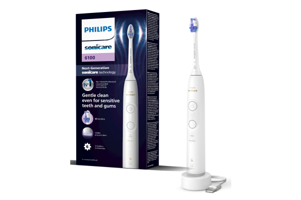 Електрична зубна щітка Philips Sonicare HX7400/01 із зарядним пристроєм поруч із упаковкою продукту