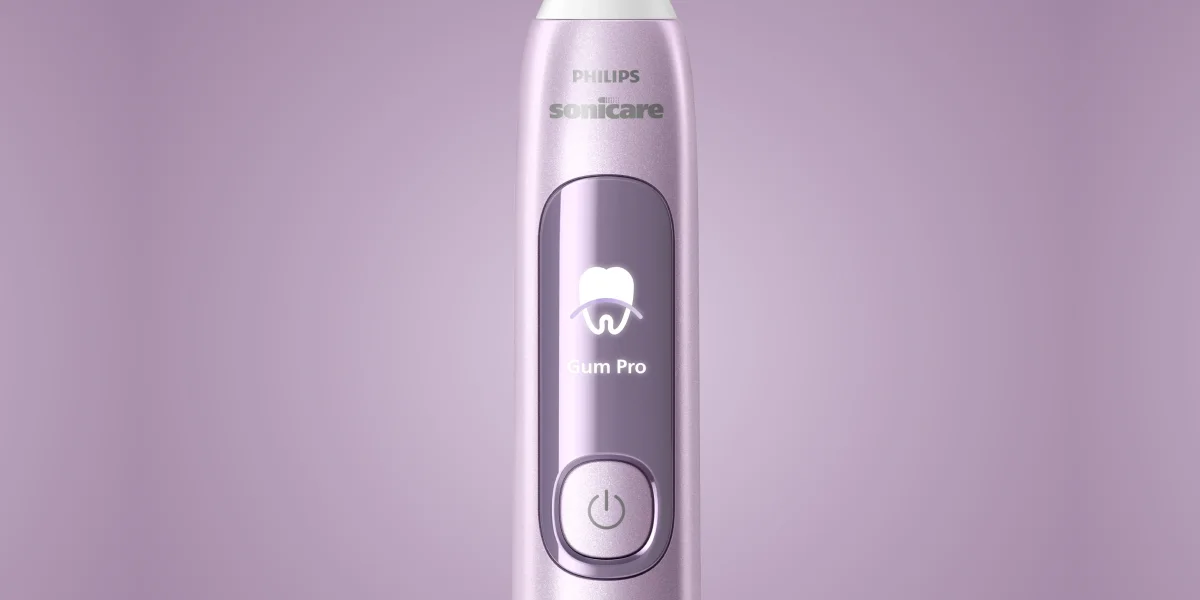 Крупний план панелі зубної щітки Philips Sonicare, режим Gum Pro з іконкою зуба та підсвіченою кнопкою живлення